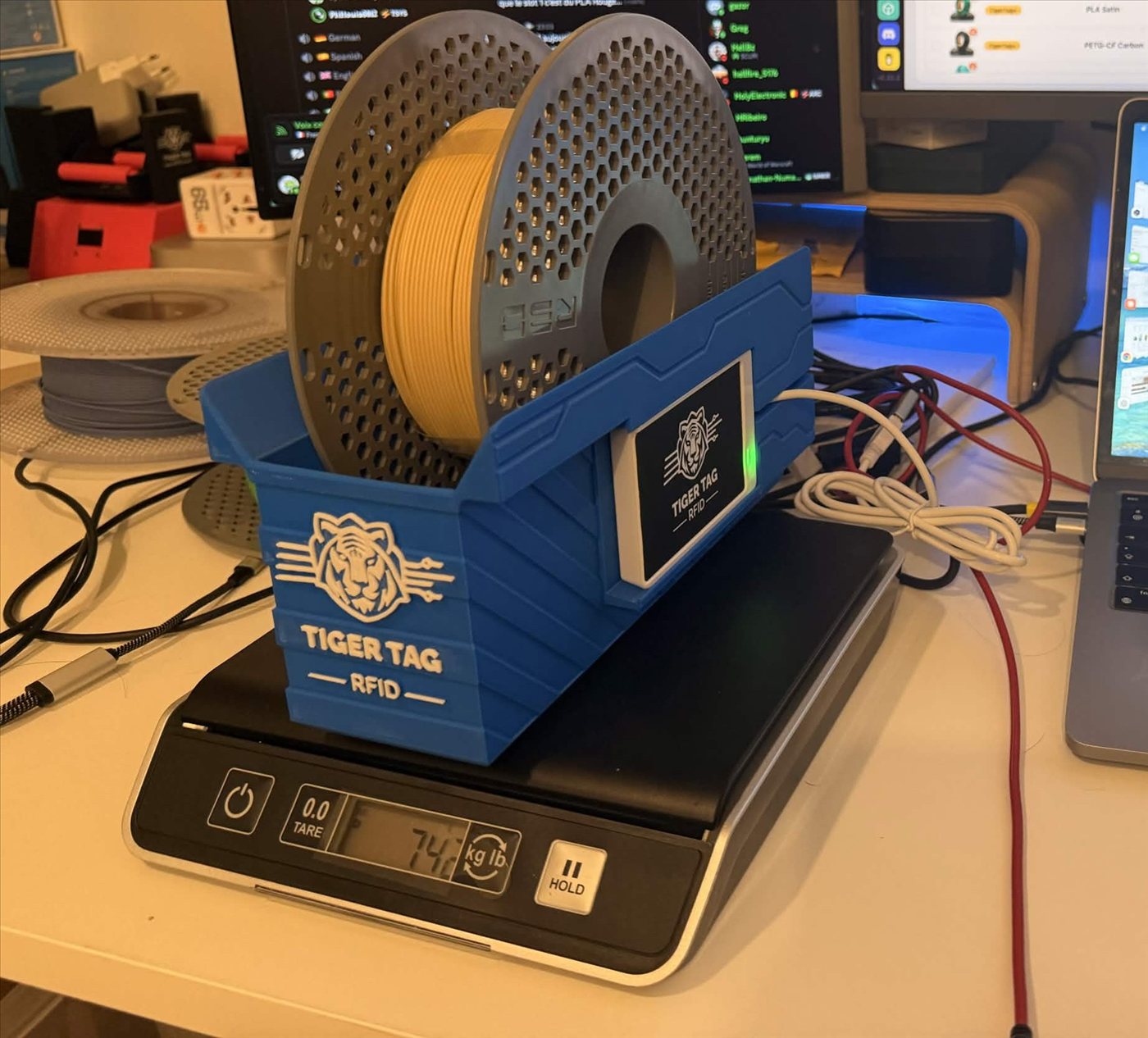 A TigerPOD sitting on a DYMO scale, weighing a tagged spool